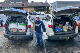 Volunteer Rich Duffy collects donated items at the luncheon.
